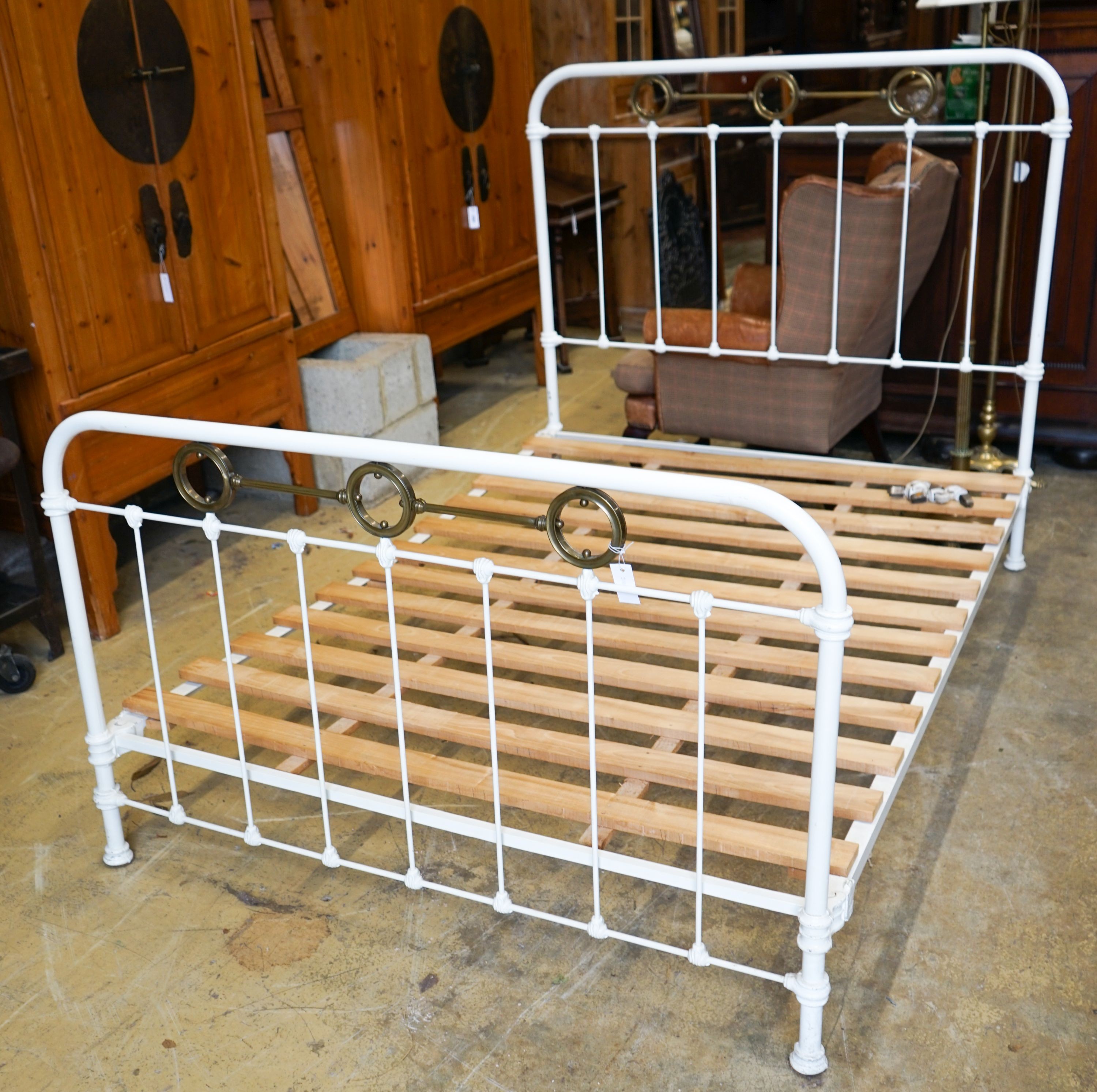 A large late Victorian iron and brass bed frame, width 140cm, length 196cm, height 130cm